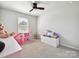 Cozy bedroom featuring neutral carpet and decor, plus bright furnishings and toys at 2678 Wedgewood Ct, Denver, NC 28037