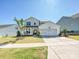 Charming two-story home with a well-manicured lawn and attached two-car garage at 2678 Wedgewood Ct, Denver, NC 28037