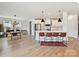 Open-concept kitchen features white cabinets, stainless appliances, a large island, and an adjacent dining area at 2678 Wedgewood Ct, Denver, NC 28037