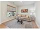 Cozy living room featuring a comfortable beige sofa, a large window, and neutral decor at 2678 Wedgewood Ct, Denver, NC 28037