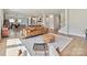 Bright living room showcasing a tan leather couch, a wooden coffee table, and an open floor plan at 2678 Wedgewood Ct, Denver, NC 28037