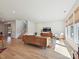 Sunlit living room boasts wood floors, modern decor, and staircase access to upper floors at 2678 Wedgewood Ct, Denver, NC 28037