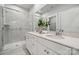 Bright bathroom with double vanity, quartz countertops, and a glass-enclosed shower at 3042 Finchborough Ct # 235, Charlotte, NC 28269