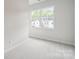 Bedroom with window views of surrounding neighborhood homes and street at 3042 Finchborough Ct # 235, Charlotte, NC 28269