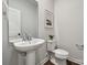 Modern powder room with a pedestal sink and a sleek, minimalist design at 3042 Finchborough Ct # 235, Charlotte, NC 28269