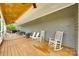 Spacious back porch with wood floors, wood ceiling, rocking chairs, and hot tub at 3091 Old Meeting House Rd, Sharon, SC 29742