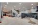 Large basement area with white staircase, concrete floors, and unique design elements at 3091 Old Meeting House Rd, Sharon, SC 29742