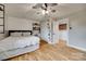 Bright bedroom featuring hardwood floors, a ceiling fan, and industrial shelving above the bed at 3091 Old Meeting House Rd, Sharon, SC 29742