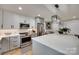 Stylish kitchen featuring stainless steel appliances, gray cabinets, a large island, and modern pendant lighting at 3091 Old Meeting House Rd, Sharon, SC 29742