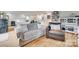 Open living room features a sofa, hardwood floors, and shiplap walls at 3091 Old Meeting House Rd, Sharon, SC 29742