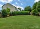 Spacious backyard with lush green grass and various trees and plants surrounding the space at 3224 Dunbar Ln, Fort Mill, SC 29707