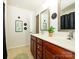 Charming bathroom featuring a double vanity with wood cabinets and decorative wall art at 3224 Dunbar Ln, Fort Mill, SC 29707