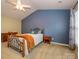 Bright bedroom featuring an ornate metal bed frame, neutral carpet, and a large window at 3224 Dunbar Ln, Fort Mill, SC 29707