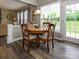 Cozy dining area features a round table, wood floors, and a bright window view of the outdoors at 3224 Dunbar Ln, Fort Mill, SC 29707