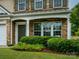 Close-up of front entrance featuring stone facade, well maintained landscaping and classic architecture at 3224 Dunbar Ln, Fort Mill, SC 29707