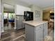 Open kitchen design features an island, black appliances, and views into the dining and living areas at 3224 Dunbar Ln, Fort Mill, SC 29707