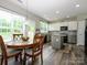 Bright kitchen with modern appliances, island, and eat-in table area with hardwood floors at 3224 Dunbar Ln, Fort Mill, SC 29707