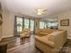 Inviting living room featuring a ceiling fan, fireplace, and views into the kitchen and dining areas at 3224 Dunbar Ln, Fort Mill, SC 29707
