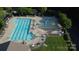 Aerial view of a community pool with lap lanes, splash area, and ample lounge seating at 3224 Dunbar Ln, Fort Mill, SC 29707