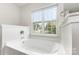 The bathtub features a large window at 3312 James Rd, Charlotte, NC 28215