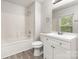 Bathroom featuring white vanity, tiled shower-tub, and light gray walls at 3312 James Rd, Charlotte, NC 28215