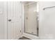 Glass-enclosed shower with white tiled walls at 3312 James Rd, Charlotte, NC 28215