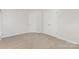 Bedroom featuring two closets and neutral carpet at 3312 James Rd, Charlotte, NC 28215