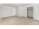 Bedroom with neutral walls, plush carpeting, and a walk-in closet at 3312 James Rd, Charlotte, NC 28215