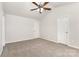 Bedroom featuring neutral carpet, ceiling fan and two doors at 3312 James Rd, Charlotte, NC 28215
