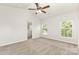 Spacious bedroom offers a ceiling fan, two windows, and neutral carpet at 3312 James Rd, Charlotte, NC 28215