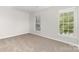 Bedroom featuring neutral carpet and two windows at 3312 James Rd, Charlotte, NC 28215