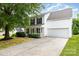 Charming two-story home with a well-manicured lawn, attached garage, and inviting front porch at 3312 James Rd, Charlotte, NC 28215