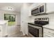 Well-equipped kitchen featuring stainless steel appliances, sleek countertops, and white cabinetry at 3312 James Rd, Charlotte, NC 28215