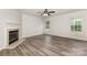 Spacious living room with a fireplace, modern flooring, and large windows offering natural light at 3312 James Rd, Charlotte, NC 28215