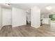 Open-concept room with new flooring, fresh paint, and access to the kitchen and stairway at 3312 James Rd, Charlotte, NC 28215