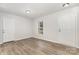 Bright room with fresh paint, modern flooring, two doors, and a window providing ample natural light at 3312 James Rd, Charlotte, NC 28215