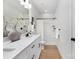 Clean bathroom with a double vanity, modern fixtures, and a combined shower and tub with white tiling at 3314 & 3316 Cedarhurst Dr, Charlotte, NC 28269