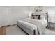 Neutral bedroom with a cozy gray bed, stylish throw pillows, and a soft rug on light wood floors at 3314 & 3316 Cedarhurst Dr, Charlotte, NC 28269