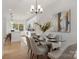 Bright dining room featuring a glass table, modern chandelier, and a view into the adjacent kitchen at 3314 & 3316 Cedarhurst Dr, Charlotte, NC 28269