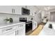 Modern kitchen with stainless steel appliances, white subway tile backsplash, and light wood floors at 3314 & 3316 Cedarhurst Dr, Charlotte, NC 28269
