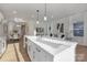 Bright kitchen featuring an island, quartz countertops, stainless appliances, and open to the dining room at 3314 & 3316 Cedarhurst Dr, Charlotte, NC 28269
