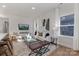Inviting living room with neutral tones, stylish decor, large windows, and comfortable seating arrangements at 3314 & 3316 Cedarhurst Dr, Charlotte, NC 28269