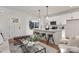 Open concept living area with a view of the modern kitchen featuring a quartz island and bar seating at 3314 & 3316 Cedarhurst Dr, Charlotte, NC 28269