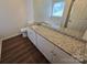 Bathroom featuring a granite vanity top and hardwood floors at 3912 Laurel View Cir, Indian Trail, NC 28079