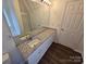 Bathroom features a granite vanity top, white cabinets, and hardwood flooring at 3912 Laurel View Cir, Indian Trail, NC 28079