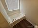 Close up of a soaking tub with chrome fixtures and a window at 3912 Laurel View Cir, Indian Trail, NC 28079