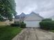 Charming two-story home with a stone-accented facade and a well-manicured front yard at 3912 Laurel View Cir, Indian Trail, NC 28079