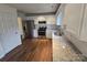 Modern kitchen features white cabinets, granite countertops, stainless steel appliances, and hardwood floors at 3912 Laurel View Cir, Indian Trail, NC 28079