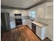 Bright kitchen with white cabinets, stainless steel appliances, granite countertops, and hardwood floors at 3912 Laurel View Cir, Indian Trail, NC 28079
