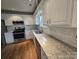 Updated kitchen featuring white cabinets, subway tile backsplash, granite counters, and stainless steel appliances at 3912 Laurel View Cir, Indian Trail, NC 28079